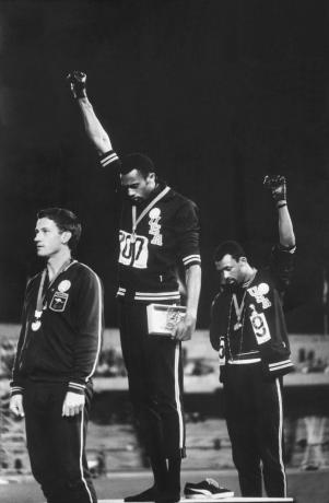 Fotografi af afroamerikanske amerikanske baneteammedlemmer Tommie Smith og John Carlos, der hæver handskede Black Power-næve som borgerrettighedsprotest under medaljeseremonien ved OL i 1968 i Mexico City