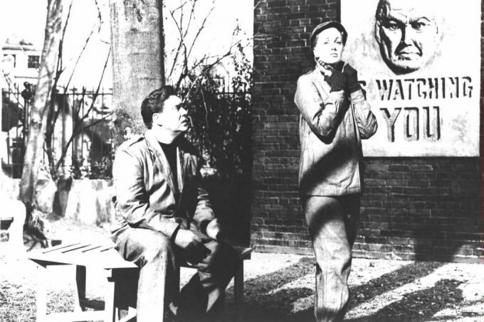 Skuespillerne Edmond O'Brien og Jan Sterling med en Big Brother-plakat bag sig i en stillbillede fra filmversionen af ​​George Orwells roman '1984.'