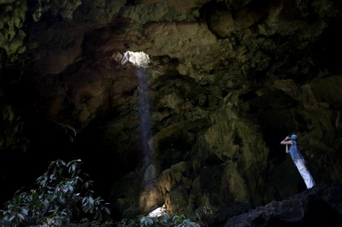 En turist tager billeder ved indgangen til Calcehtok-hulen i Oxkintok, staten Yucatan på Mexicos Yucatan-halvø.